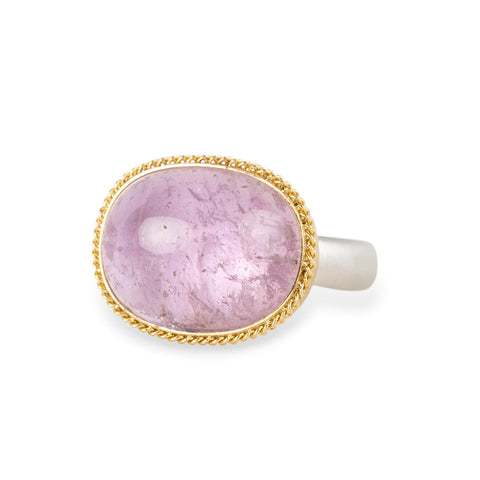 A gold and silver ring featuring a pink kunzite stone, shown against a white background