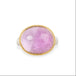An oval kunzite ring with a gold bezel and sterling silver band, against a white background