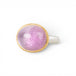 An oval kunzite ring with a gold bezel and sterling silver band, against a white background