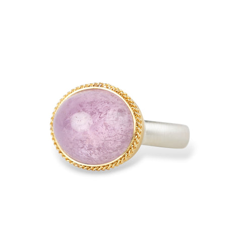 A gold and silver ring featuring a pink kunzite stone, shown against a white background.