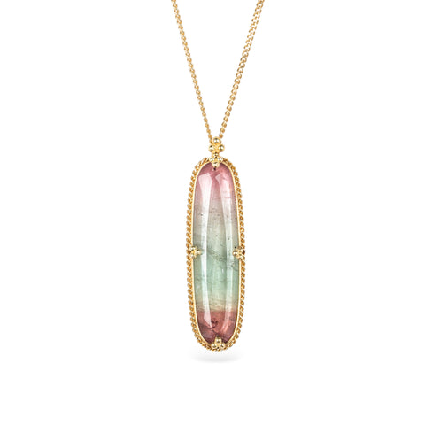 Handmade necklace with a watermelon tourmaline gemstone set in a gold bezel on a white background