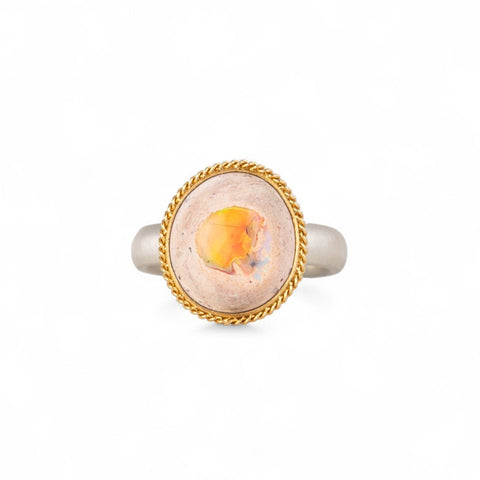 Handcrafted fine jewelry ring with a mexican opal gemstone set in an 18k gold bezel with a sterling silver band