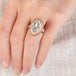 Close-up of a hand wearing a silver and gold ring with a mexican opal stone