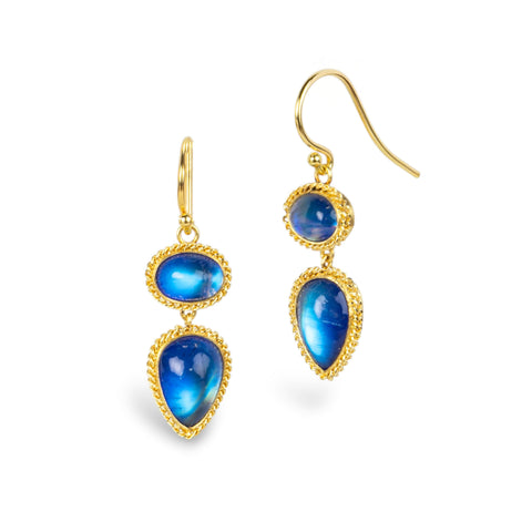 A pair of gold drop earrings with vibrant blue moonstone gemstones, featuring double-stone designs, set against a plain white background.