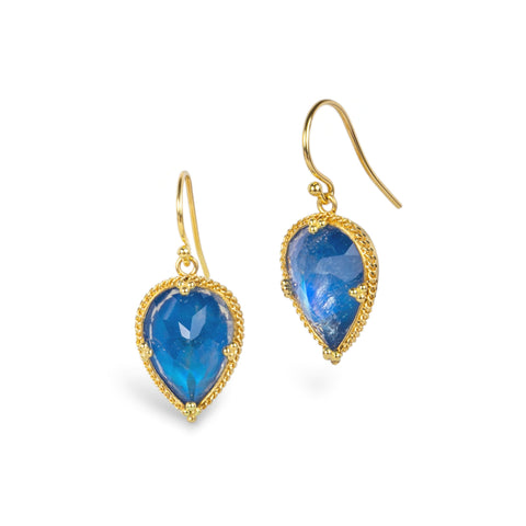 A pair of gold drop earrings featuring pear-shaped blue iridescent moonstones, set in textured gold bezels, shown on a plain white background.