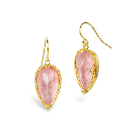 A pair of gold drop earrings featuring pear-shaped pink morganite gemstones in a textured gold bezel setting, shown on a clean white background.
