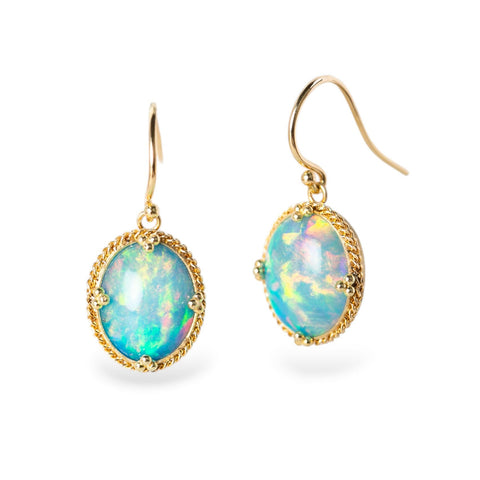 Gold earrings with Ethiopian opals on a white background