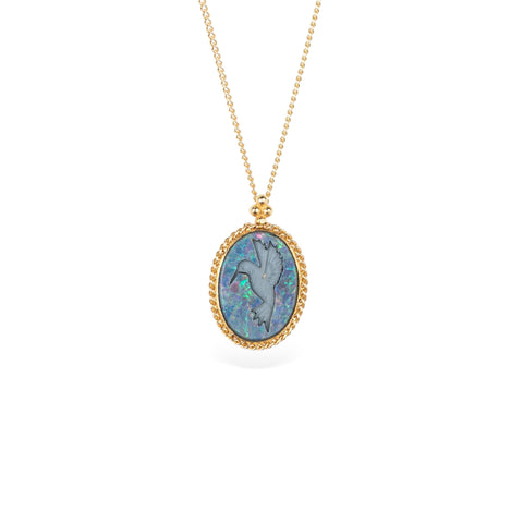 Handmade 18k yellow gold necklace featuring an opal doublet with a carved hummingbird set on a white background.