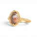 Gold ring with a sunstone on a white background