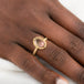 Gold ring with a sunstone on a person's finger