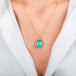 A gold necklace featuring an oval Ethiopian opal gemstone, shown worn on a model's neck.