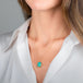 A gold necklace featuring an oval Ethiopian opal gemstone, shown worn on a model's neck.