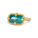 Gold ring featuring a teal pariba kyanite stone set in an 18k gold bezel, shown against a white background.