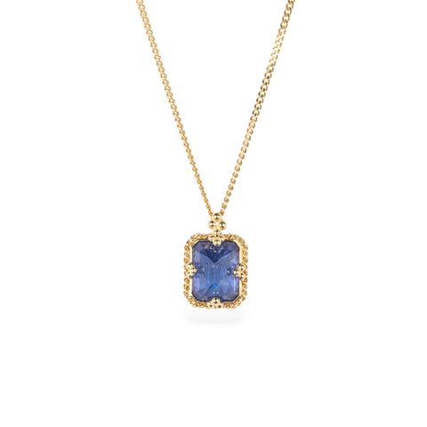 Gold necklace with a tanzanite gemstone set in a handmade gold bezel on a white background