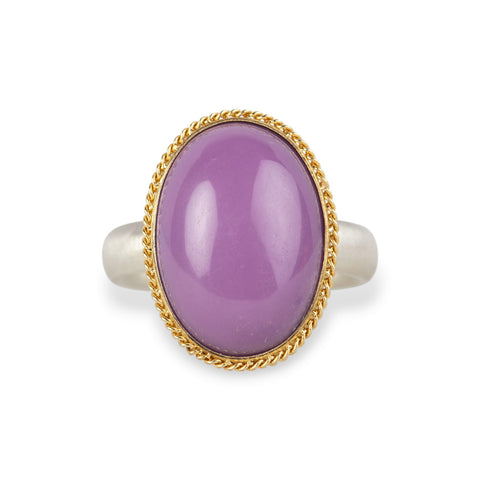 A gold and silver ring with a purple phosphosiderite stone, shown against a white background.