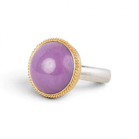 A gold and silver ring featuring a phosphosiderite stone, shown against a white background.
