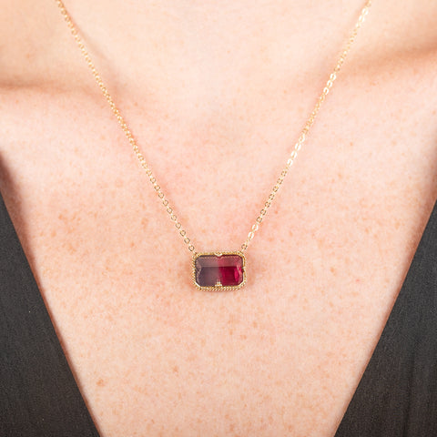 Necklace with a watermelon tourmaline gemstone pendant on a person