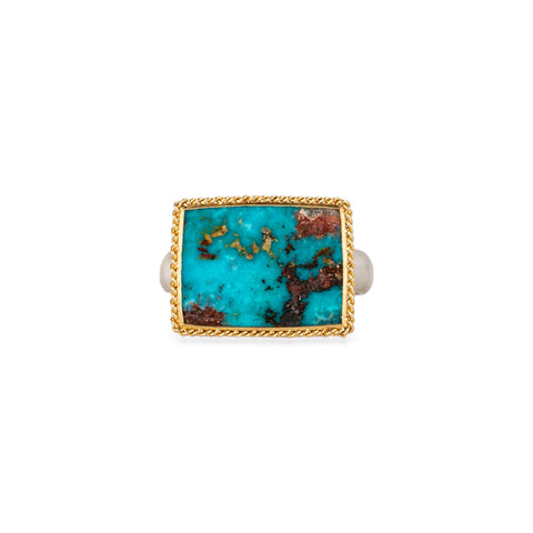 Turquoise ring with gold bezel and silver band on white background