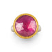 Gold and silver ring featuring a bright pink sapphire gemstone, shown against a white background.