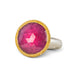 Gold and silver ring featuring a bright pink sapphire gemstone, shown against a white background.