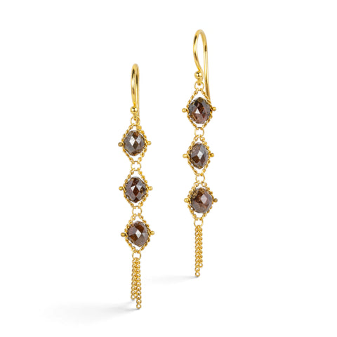 Gold earrings featuring trios of brown diamonds, shown against a white background.