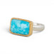 A gold ring featuring a rectangular turquoise stone set in a gold bezel with a sterling silver band against a plain white background.