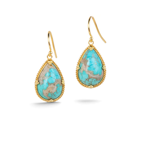 Gold earrings featuring turquoise gemstones, shown against a white background.