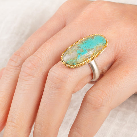 Handmade fine jewelry turquoise ring with an 18k gold bezel and sterling silver band