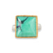 A gold and silver ring featuring a Variscite stone against a white backdrop.