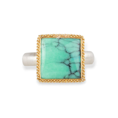 Gold and silver ring featuring a green Variscite stone against a white background