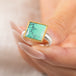 Gold and silver ring featuring a green Variscite stone held in a hang