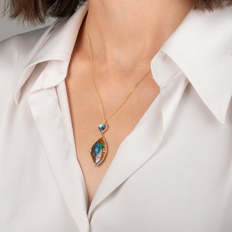 Gold Necklace featuring yowah nut opal and moonstone gemstones worn on a model's neck.