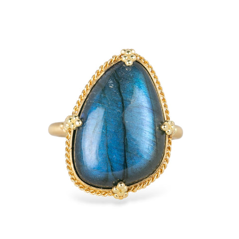 Gold ring with a labradorite gemstone on a white background