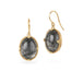 Gold earrings featuring toumalated quartz on a white background