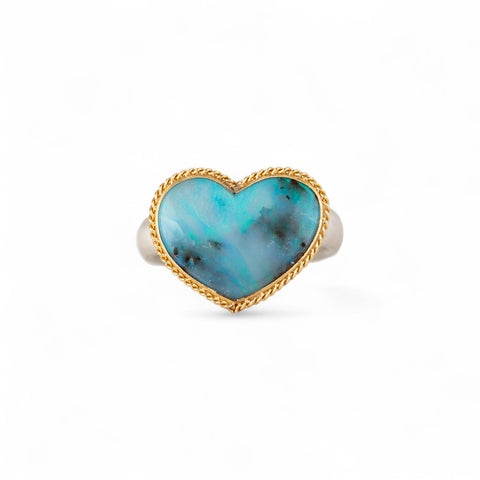 Boulder opal heart ring with a gold bezel and silver band