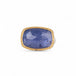 Tanzanite ring with gold bezel and sterling silver band on white background