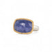 Tanzanite ring with gold bezel and sterling silver band on white background