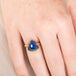 Gold ring with a tanzanite gemstone on a hand