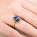 Gold ring with a tanzanite gemstone on a hand