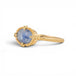 Gold ring with a blue dumortierite stone on a white background