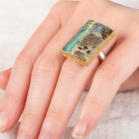 Boulder opal ring in 18k gold bezel and sterling silver band