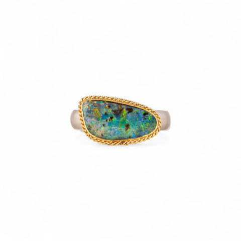 Boulder opal ring with gold bezel and sterling silver band