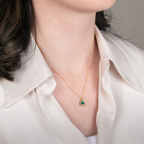 18k gold necklace featuring a boulder opal gemstone worn on a person