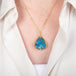 Handcrafted gold necklace with a boulder opal gemstone on a person