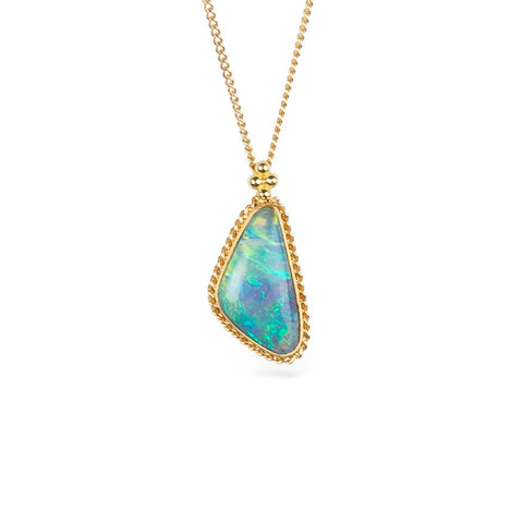 Boulder opal pendant necklace with a gold setting against a white background