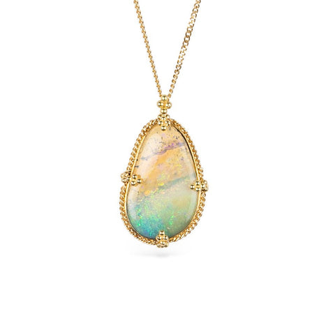 Handcrafted gold necklace featuring a boulder opal gemstone against a white background