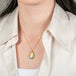 18k gold necklace featuring a boulder opal gemstone worn on a person