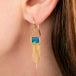 A gold drop earring featuring a rectangular boulder opal stone and cascading gold fringe, shown against a plain white background.