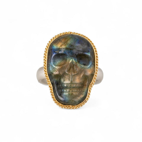 Carved labradorite skull ring set in an 18k gold bezel with a sterling silver band