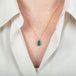 Australian opal and 18k gold necklace on a person